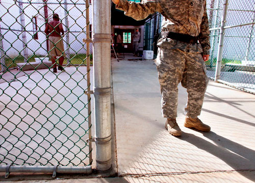 Un soldado de EEUU abre la verja en la base naval de Guantánamo. Enero, 2009. Corbis